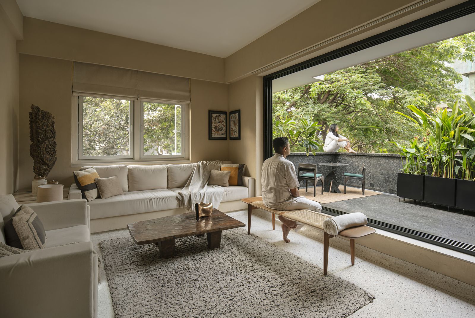 A custom-made sofa fills the wall, with a coffee table from Sun City Exports. The rug is from West Elm.