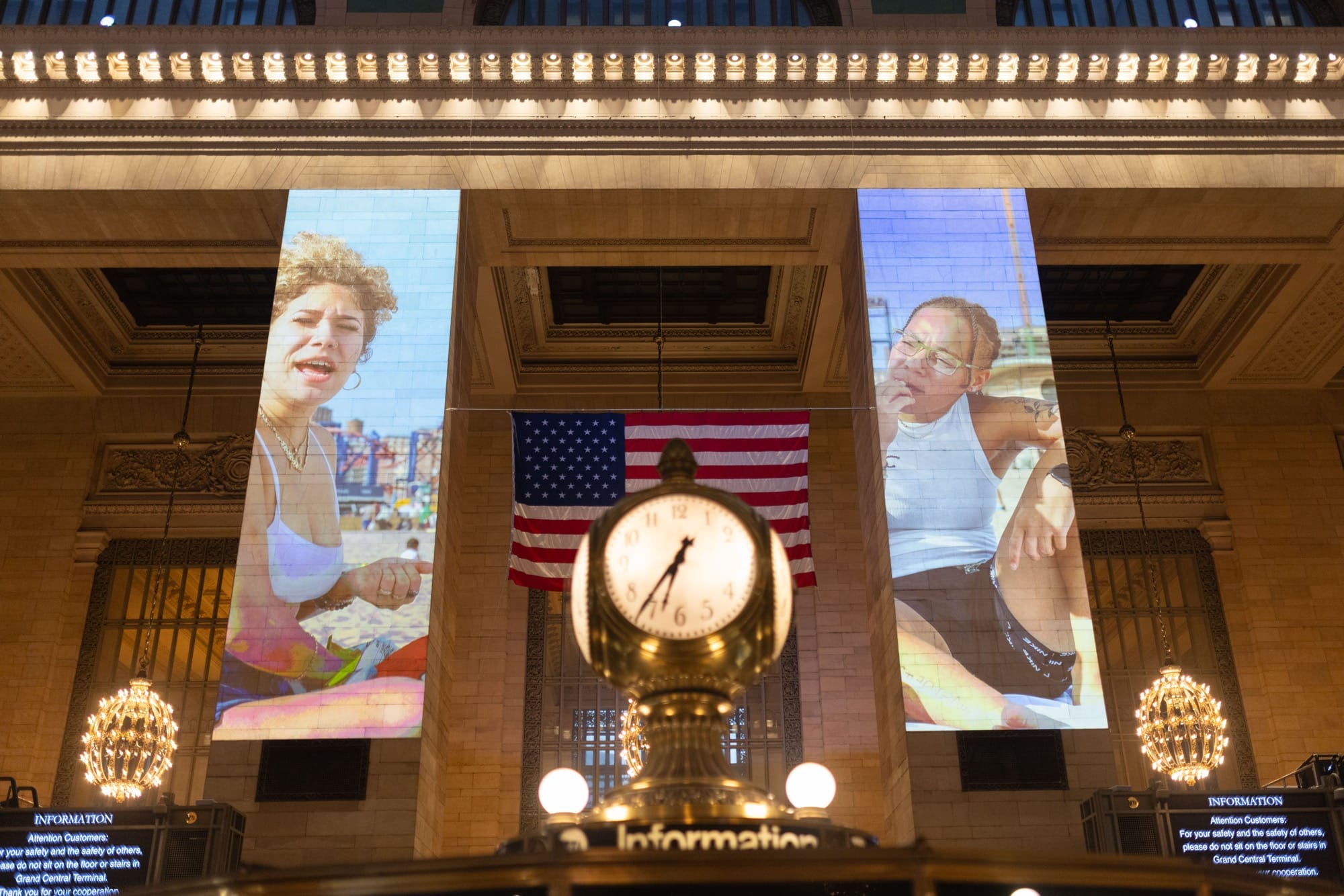a photo installation of Brandon Stanton's Dear New York projected on the architecture of Grand Central Station