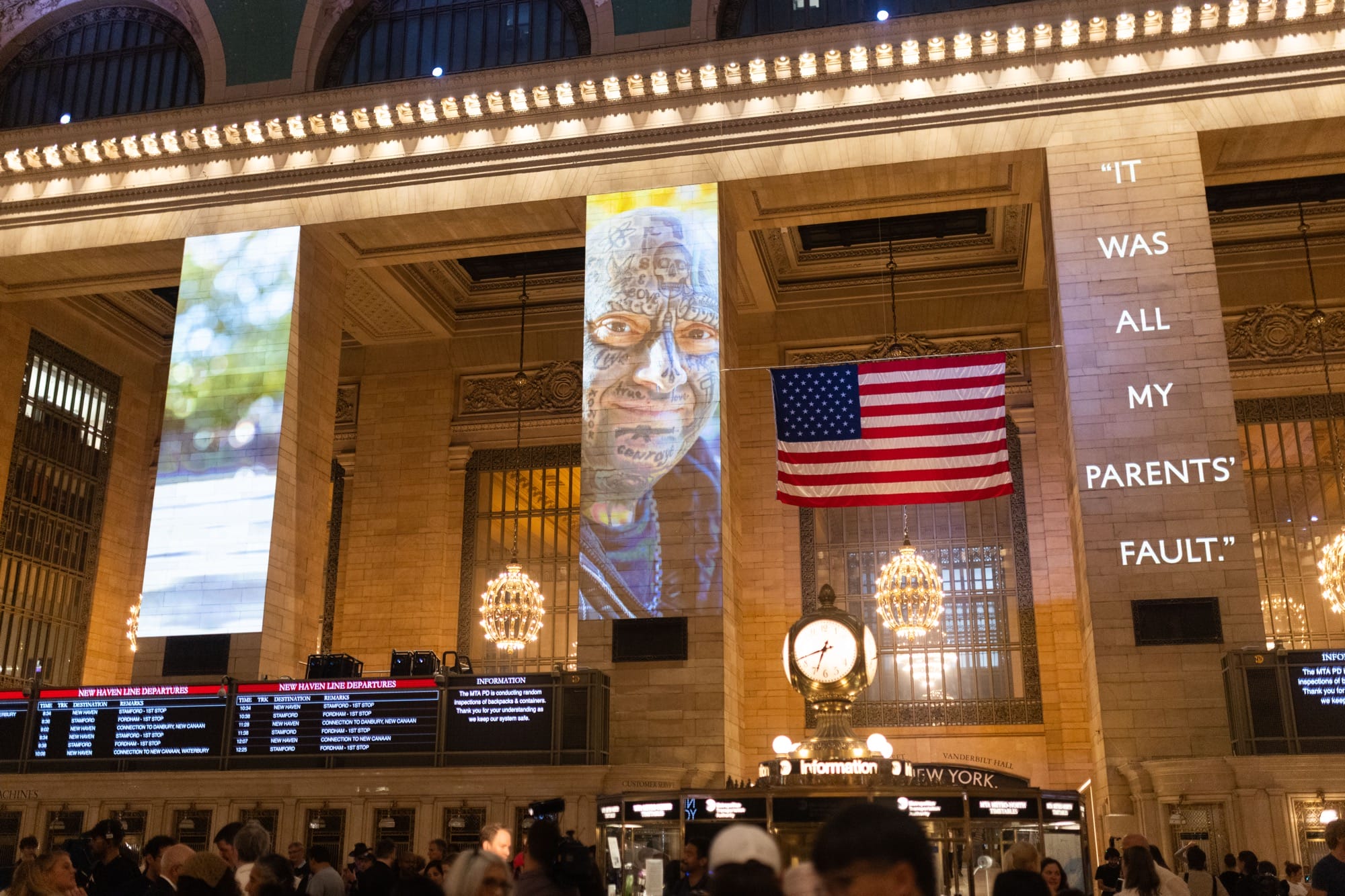 a photo installation of Brandon Stanton's Dear New York projected on the architecture of Grand Central Station