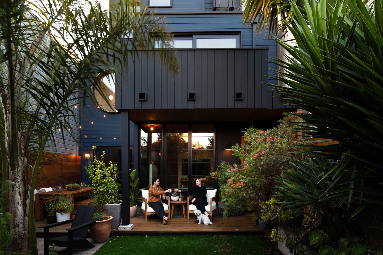 Kevin and Katie enjoy happy hour on their new covered patio. The plantings were inspired by the garden in Mexico where they got married. During the pandemic, "We were like, I want to go on vacation, but we can't, so let's just make our backyard a vacation,