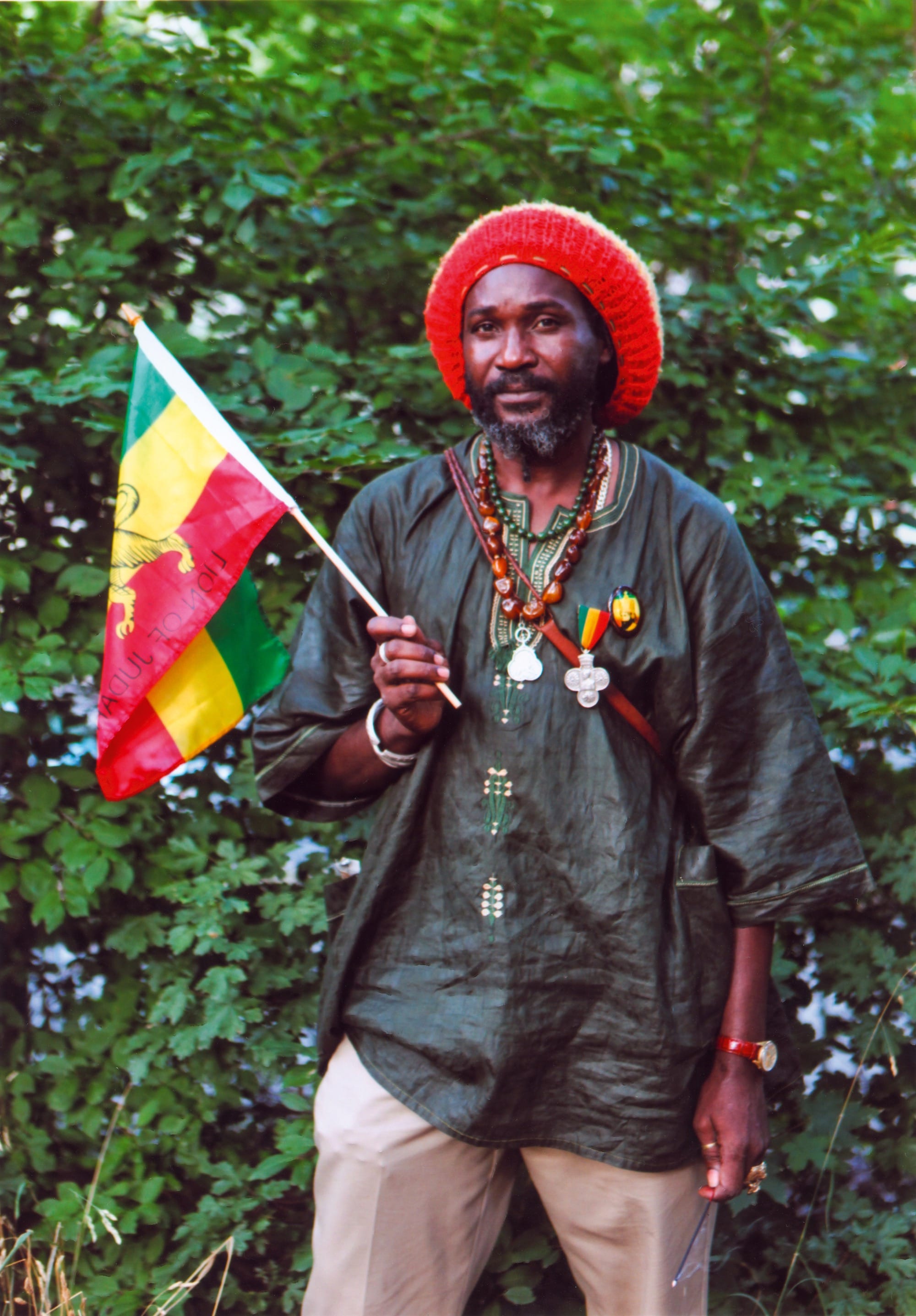 a photo by Jamel Shabazz of a man holding a Jamaican flag