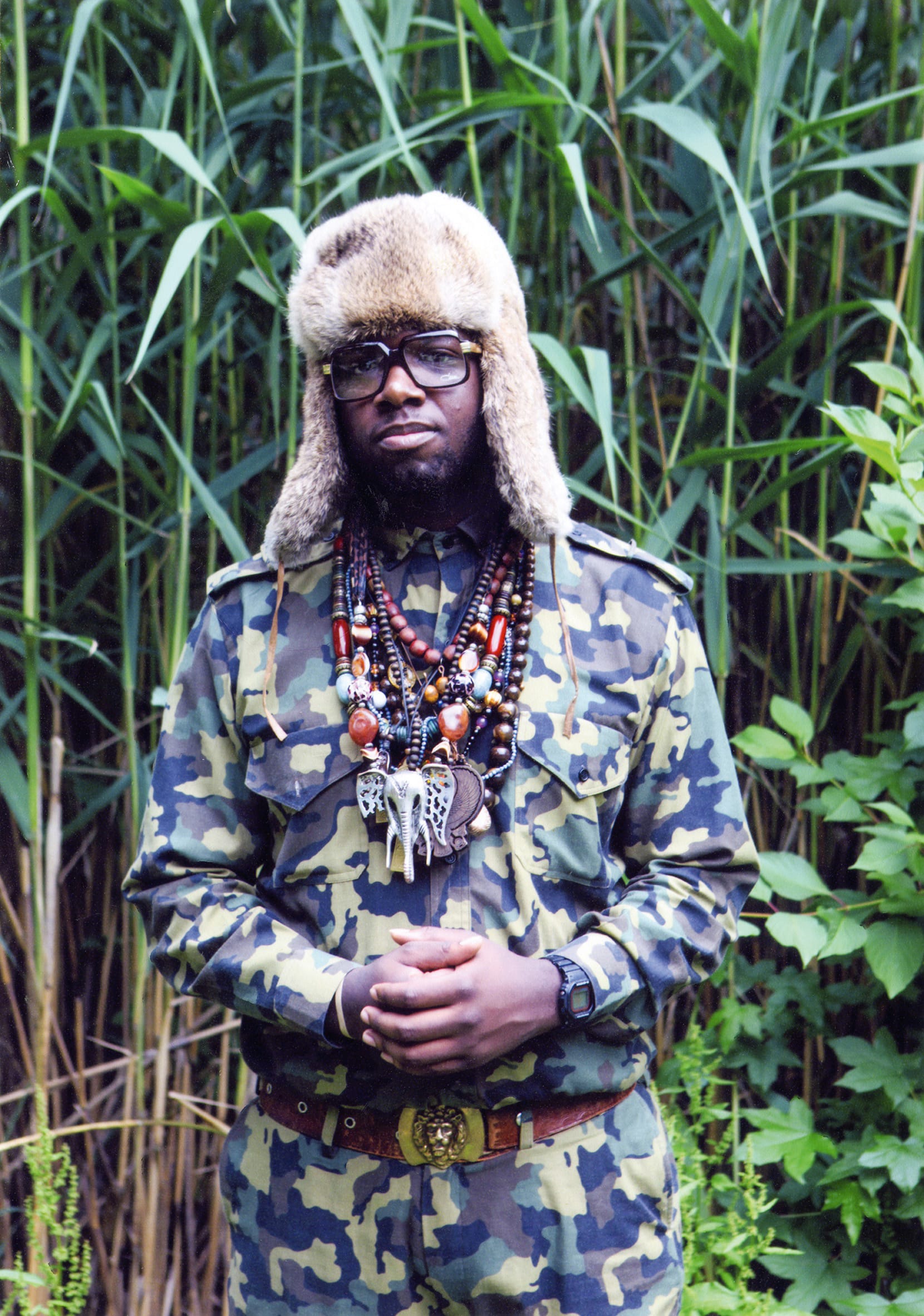 a portrait by Jamel Shabbaz of a man in army fatigues and a fur hat