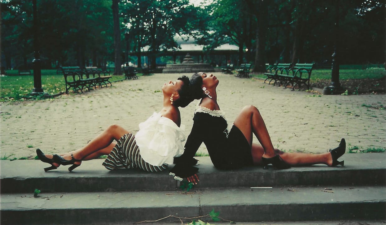 a photo by Jamel Shabbaz of two women posing with their backs together