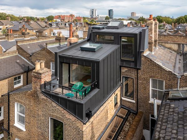 The loft extension is arranged over two levels, with the form housing the study and terrace, and the upper front section the primary bedroom and en suite.