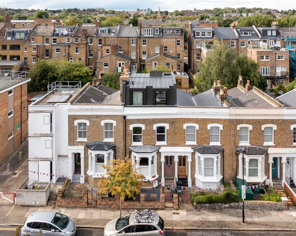 The loft extension is perched atop the red-brick terrace and clad in dark zinc—a material choice that is sensitive to the surrounding streetscape, while also immediately signifying the contemporary nature of the addition.