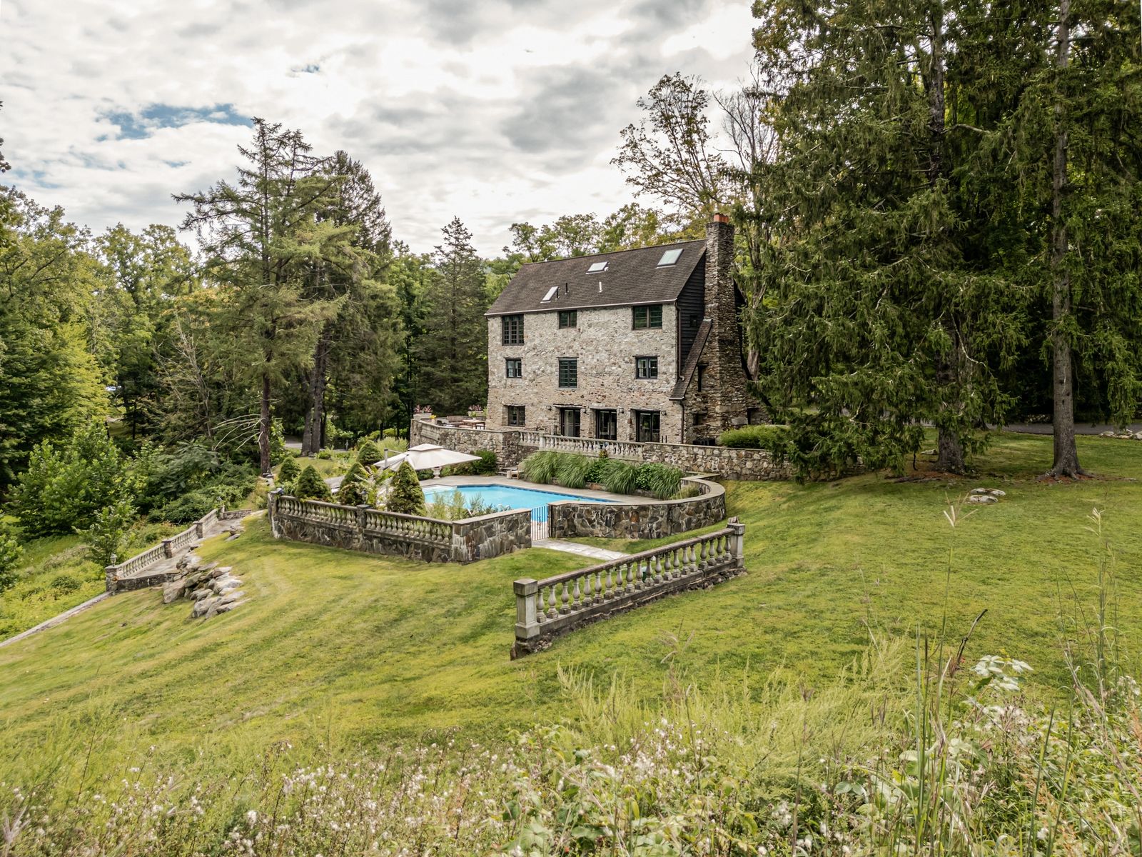 This 12-acre estate once frequented by president FDR comes with rolling hills, a creek, a heated pool, and a three-story stone residence