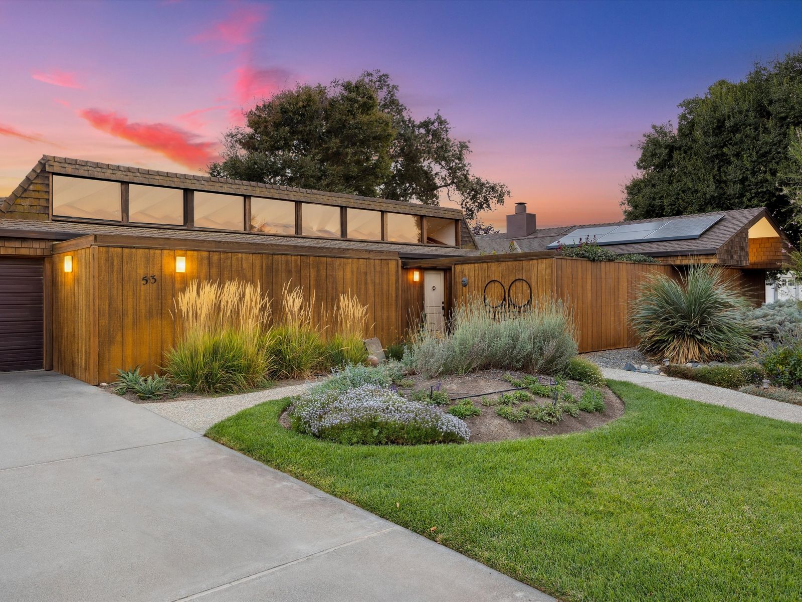 This wood-clad 1970 home has exposed beams, clerestory windows, and a big backyard with raised beds and abundant plantings.