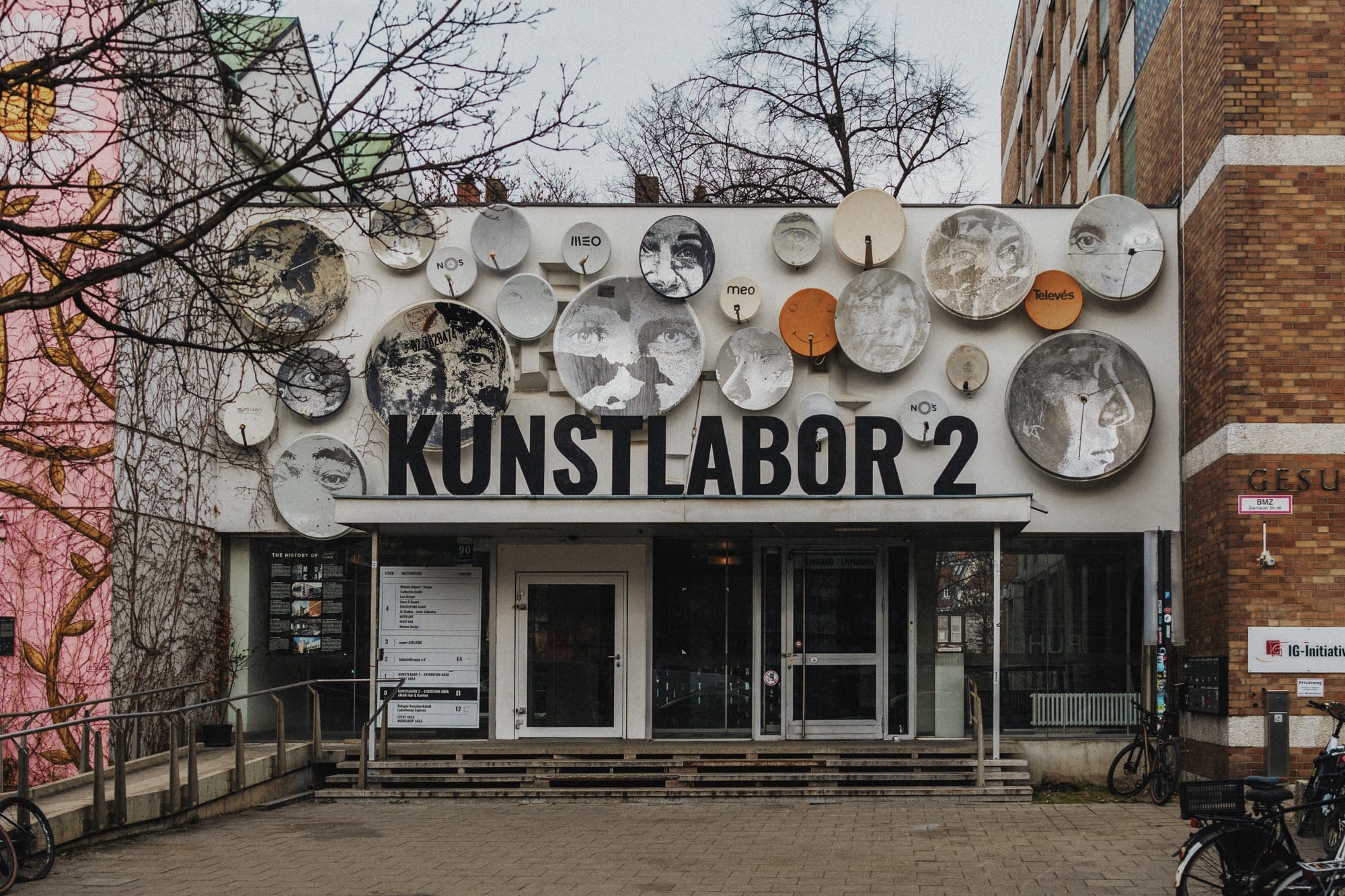 an installation by vhils of circular paintings on a building
