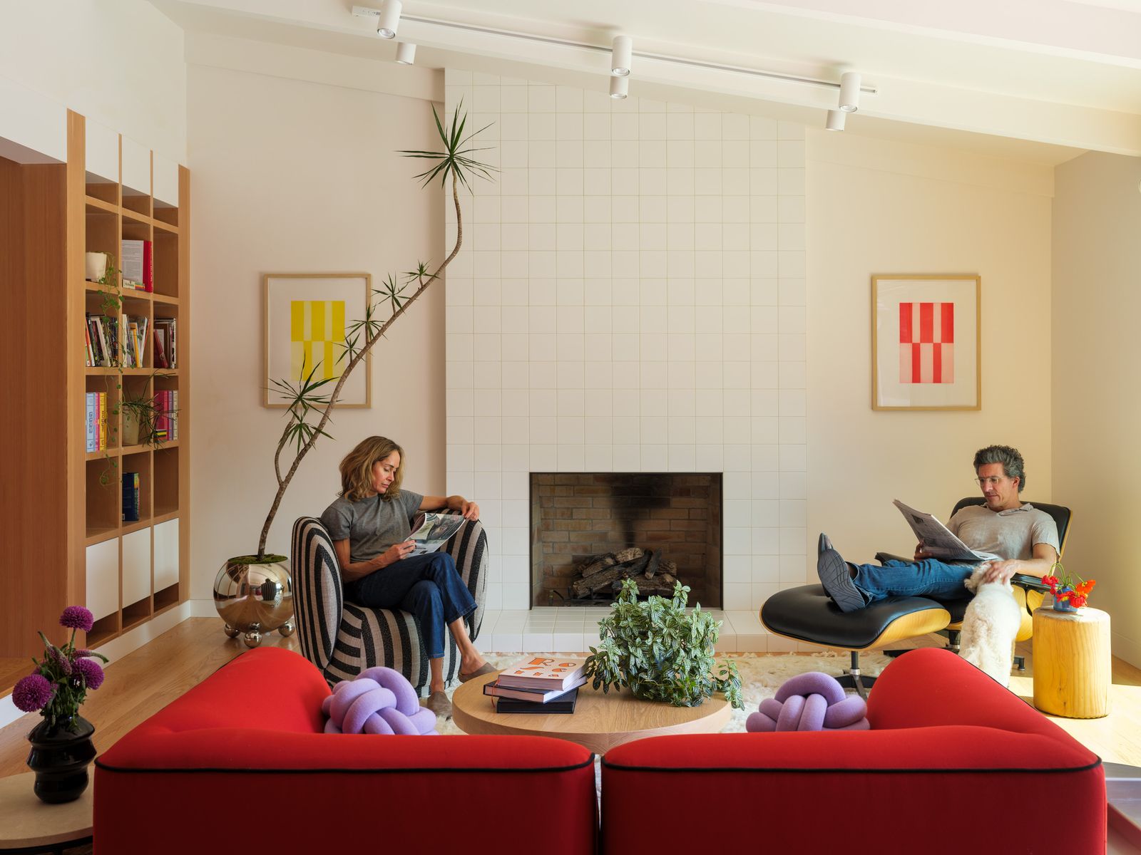 Woud’s modular sofa provides a vibrant accent color used elsewhere in the house and ADU. The striped club chair is from Ferm Living; the Eames chair and ottoman were among the only things the couple brought with them from Colorado. The knot cushions are by Design House Stockholm, and the prints are by Cornelia Thomsen.