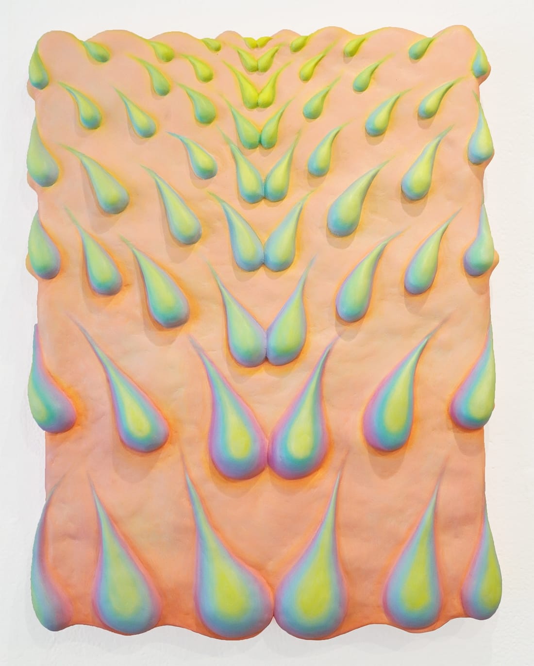 a sculptural relief by Yen Yen Chu of large droplets on a peach backdrop