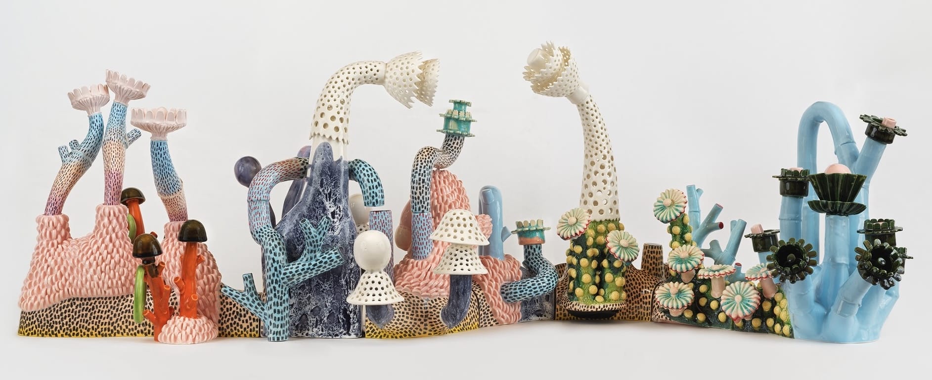 a group of ceramic sculptures by Megan Bogonovich resembling abstract flowers and plants