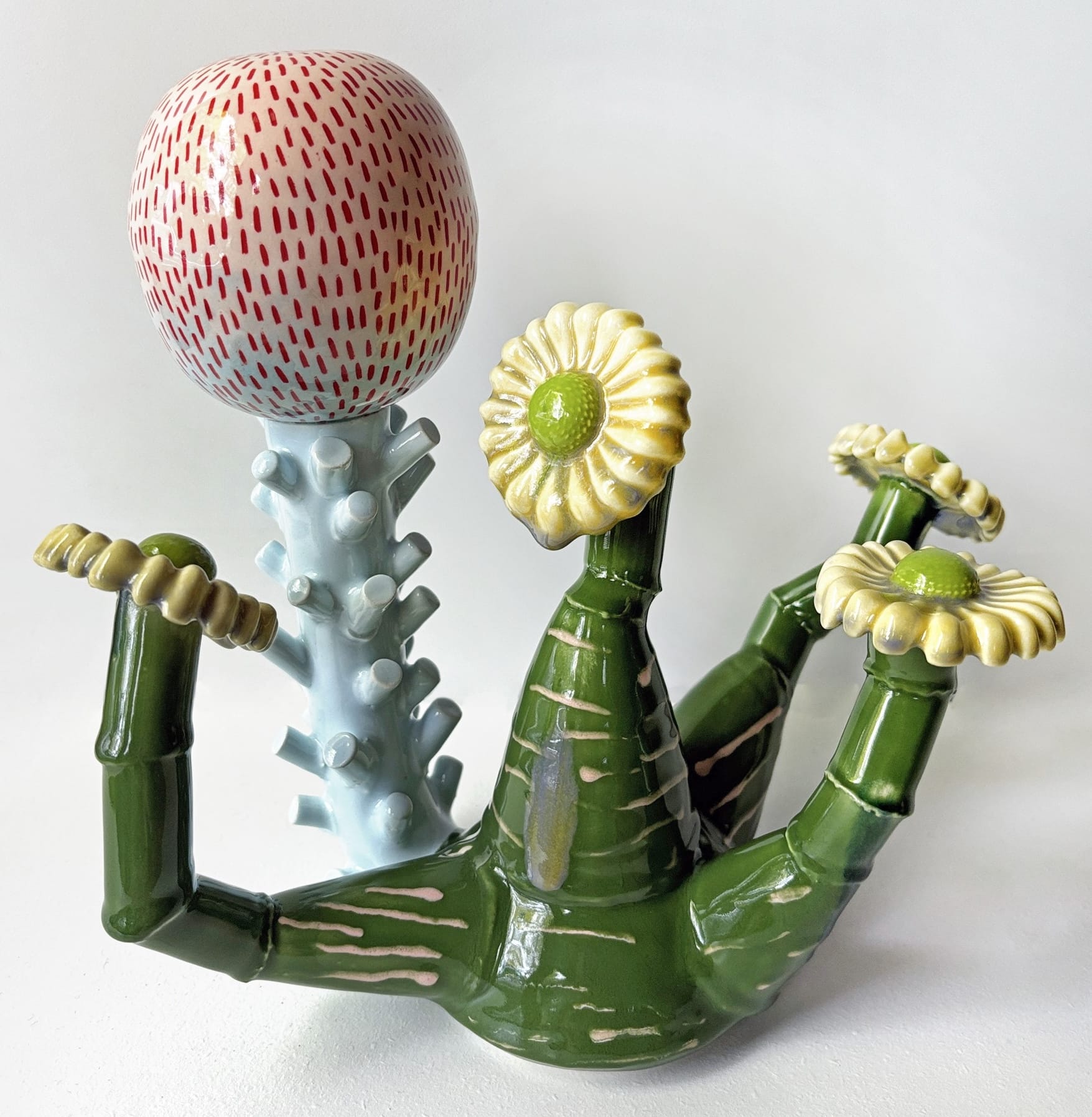 a ceramic sculpture by Megan Bogonovich resembling an abstract, otherworldly plant or flower