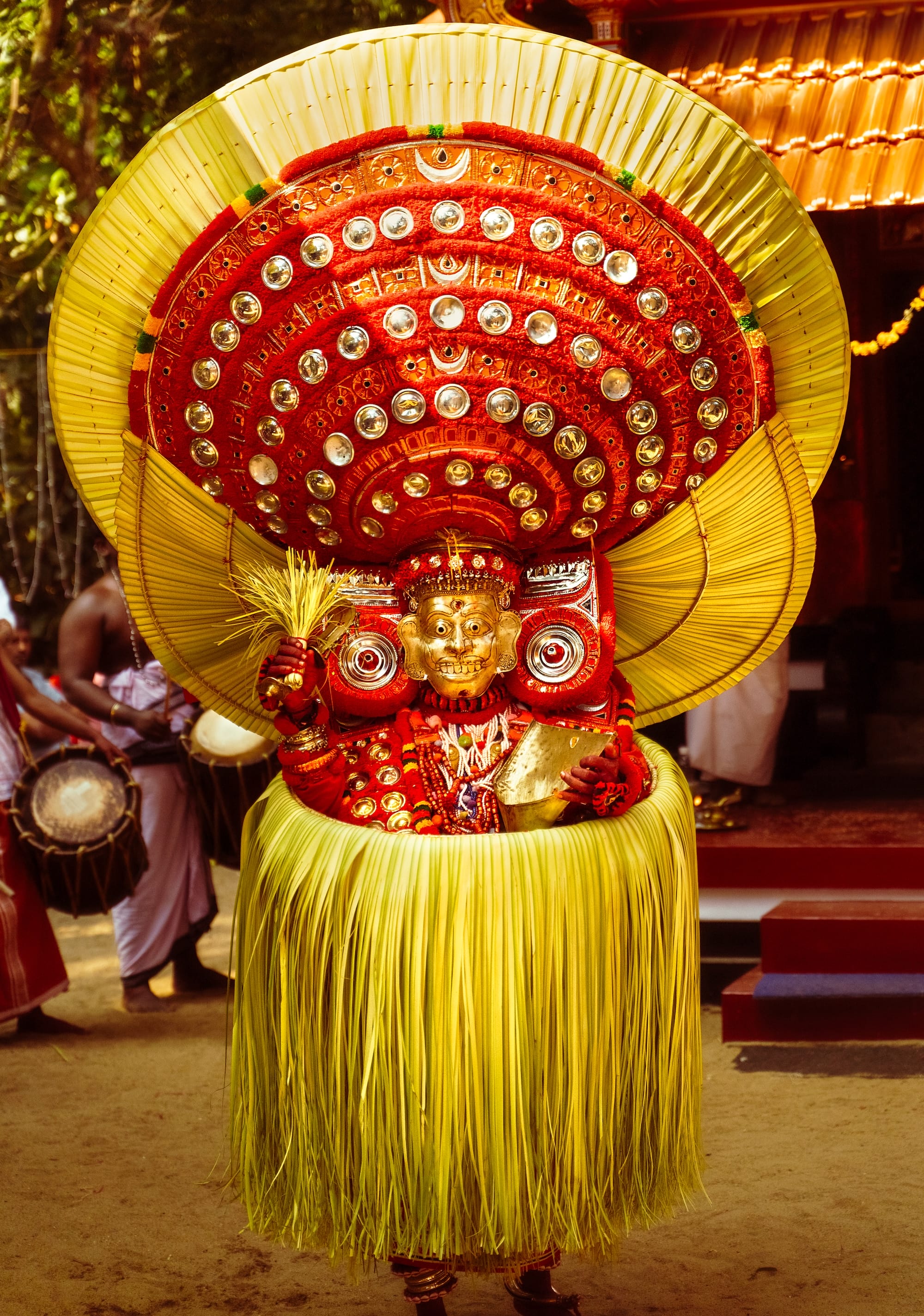 a photograph by Navneet Jayakumar of an elaborate ceremonial outfit worn by a performer for Theyyam, in Kerala, India
