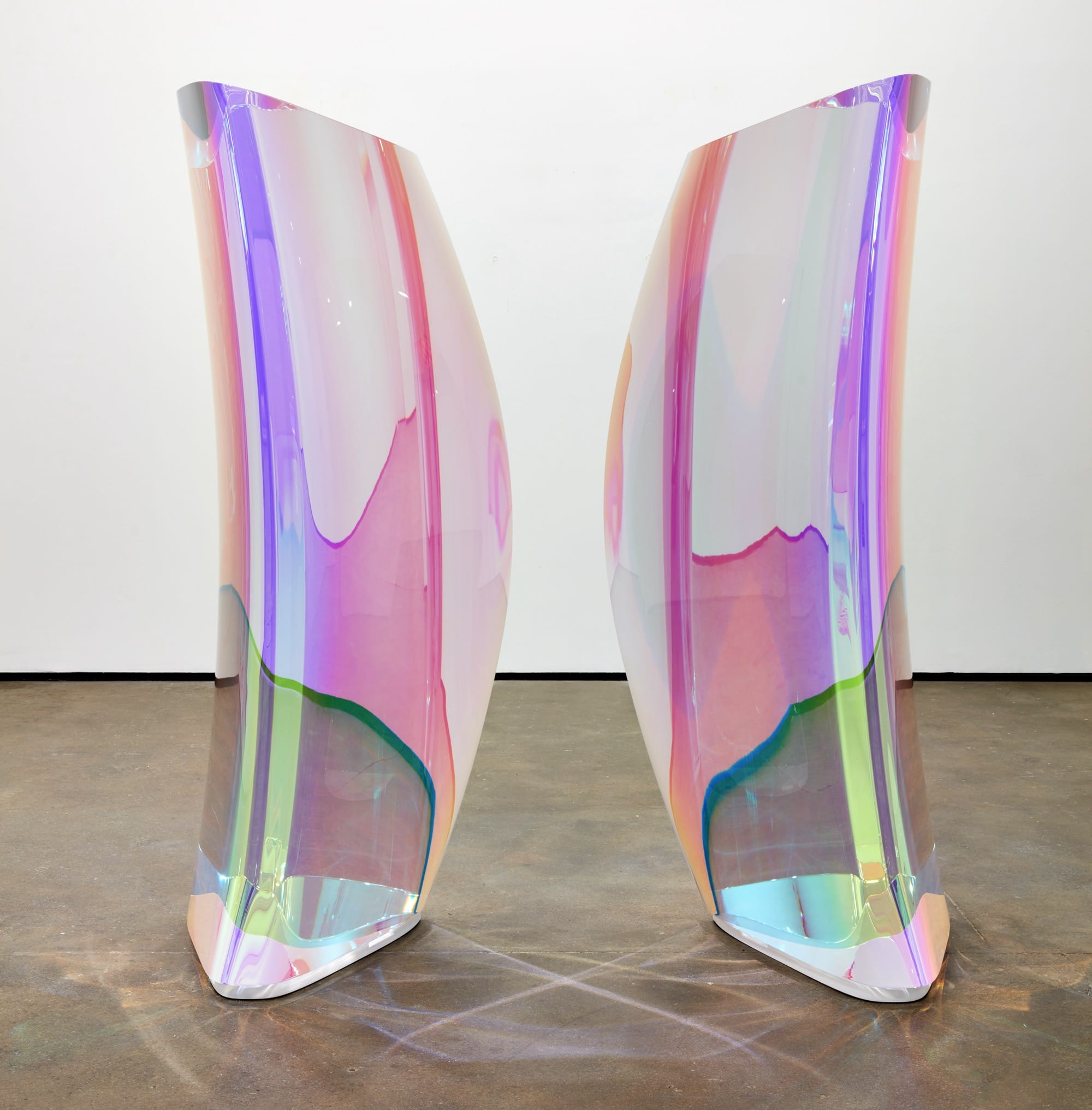 a sculpture by Mariko Mori of two translucent, mirrored acrylic forms with pinkish, prismatic colors